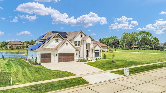 604 Cayman Way, Savoy, IL 61874 - french provincial home with roof mounted solar panels, driveway, a garage, and a water view