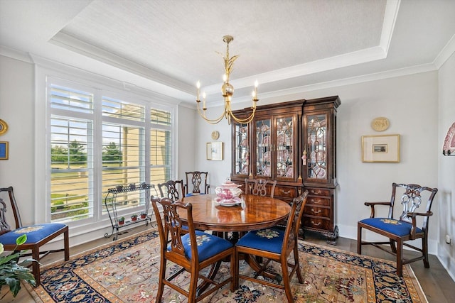 604 Cayman Way, Savoy, IL 61874 - dining space with a raised ceiling, a chandelier, dark wood-type flooring, and crown molding