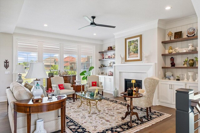 604 Cayman Way, Savoy, IL 61874 - living room featuring a ceiling fan, healthy amount of natural light, wood finished floors, crown molding, and a glass covered fireplace