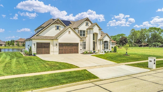 604 Cayman Way, Savoy, IL 61874 - view of front of property featuring solar panels, concrete driveway, and a water view