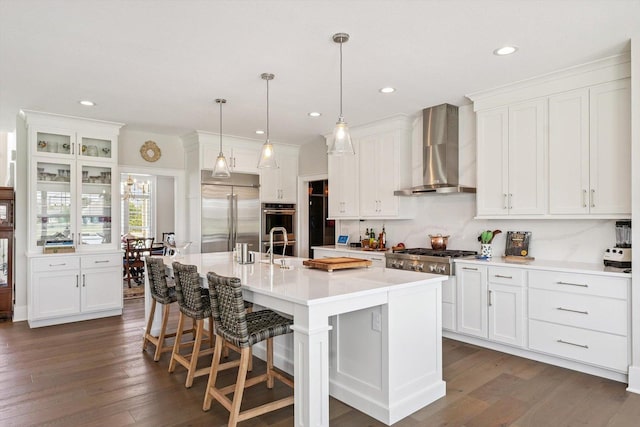 604 Cayman Way, Savoy, IL 61874 - kitchen featuring appliances with stainless steel finishes, wall chimney exhaust hood, white cabinetry, and recessed lighting