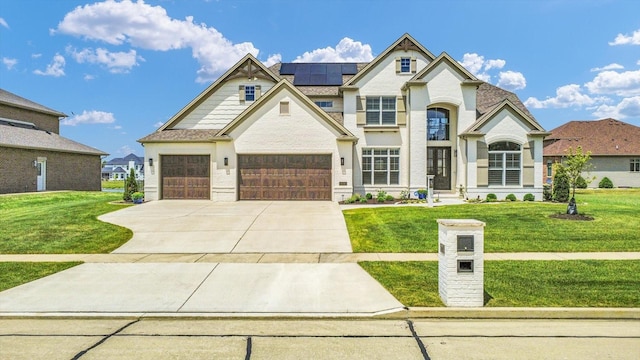 604 Cayman Way, Savoy, IL 61874 - french country inspired facade with solar panels, a front lawn, and driveway