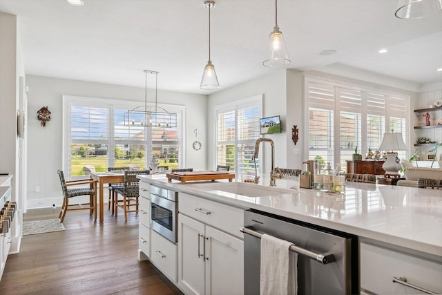 604 Cayman Way, Savoy, IL 61874 - kitchen with stainless steel appliances, white cabinets, dark wood-style floors, decorative light fixtures, and recessed lighting