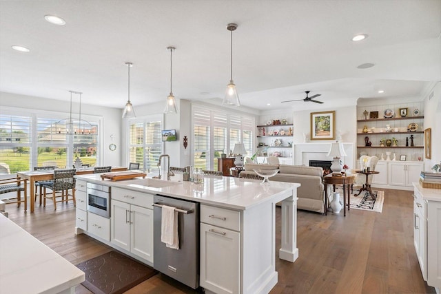 604 Cayman Way, Savoy, IL 61874 - kitchen featuring stainless steel dishwasher, white cabinets, a ceiling fan, dark wood-style floors, and hanging light fixtures