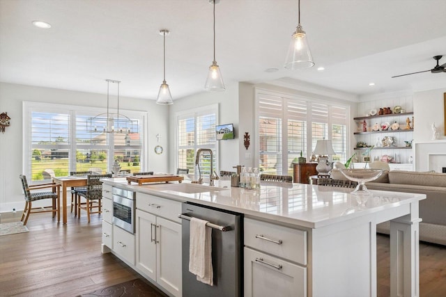 604 Cayman Way, Savoy, IL 61874 - kitchen featuring dishwasher, dark wood-style flooring, open floor plan, a ceiling fan, and white cabinetry
