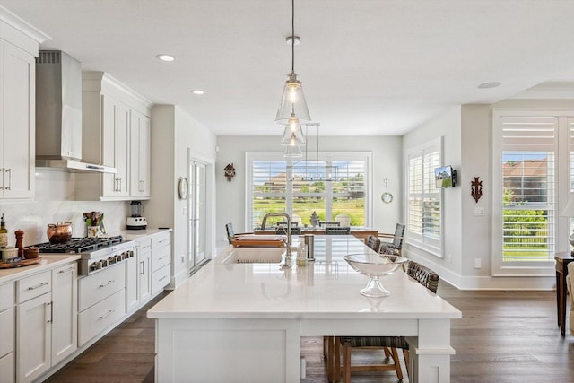 604 Cayman Way, Savoy, IL 61874 - kitchen with wall chimney exhaust hood, stainless steel gas stovetop, dark wood-style floors, recessed lighting, and a kitchen island with sink