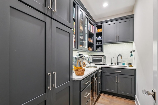 604 Cayman Way, Savoy, IL 61874 - bar area featuring light wood-style flooring, tasteful backsplash, and beverage cooler