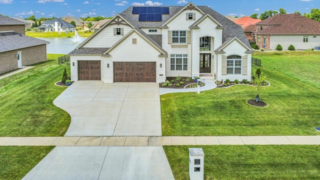 604 Cayman Way, Savoy, IL 61874 - french provincial home with concrete driveway, a front lawn, solar panels, and stucco siding