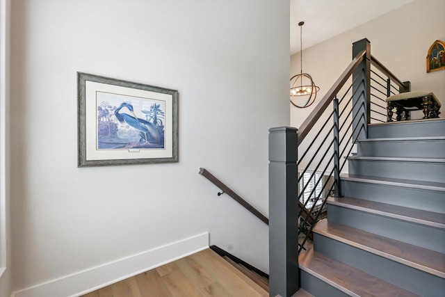 604 Cayman Way, Savoy, IL 61874 - staircase featuring wood finished floors and a chandelier