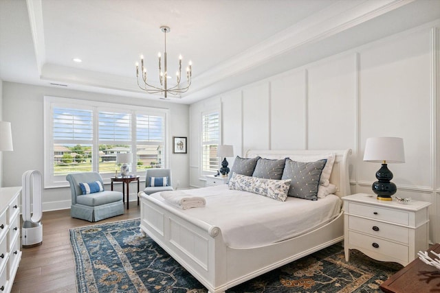 604 Cayman Way, Savoy, IL 61874 - bedroom featuring a tray ceiling, a chandelier, multiple windows, wood finished floors, and a decorative wall