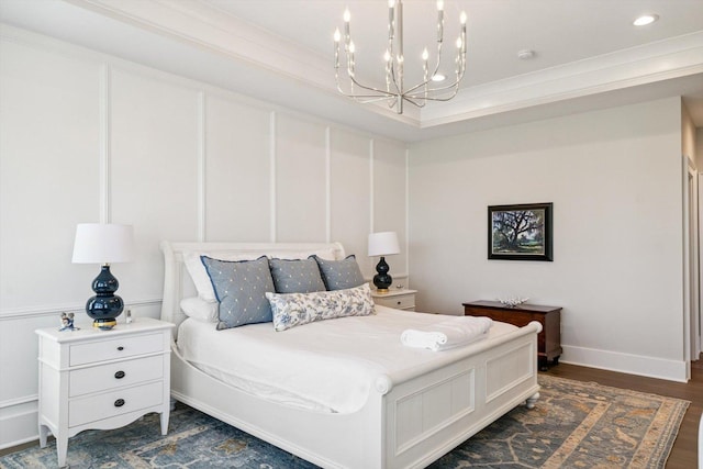 604 Cayman Way, Savoy, IL 61874 - bedroom featuring a chandelier, dark wood-style flooring, ornamental molding, recessed lighting, and a decorative wall