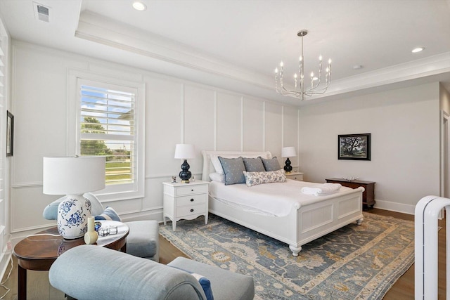 604 Cayman Way, Savoy, IL 61874 - bedroom featuring a raised ceiling, a chandelier, dark wood-type flooring, ornamental molding, and recessed lighting