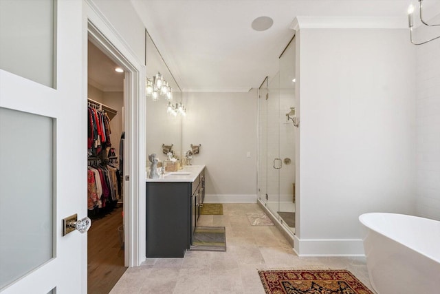 604 Cayman Way, Savoy, IL 61874 - bathroom with a stall shower, vanity, a soaking tub, a walk in closet, and crown molding