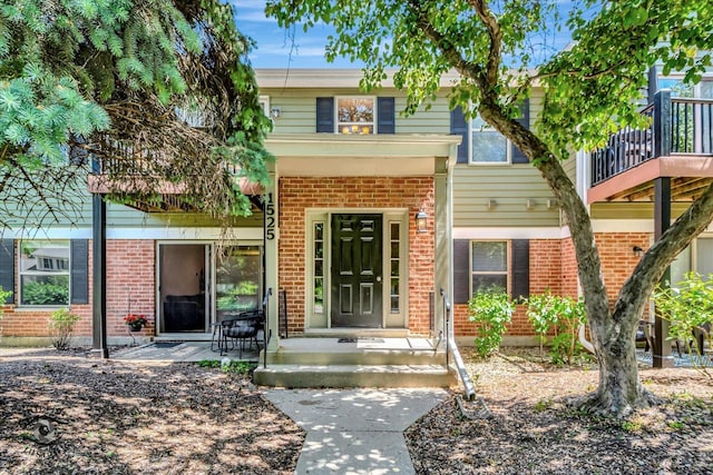 1525 Raymond Dr Unit 103, Naperville, IL 60563 - view of front facade with brick siding and a balcony