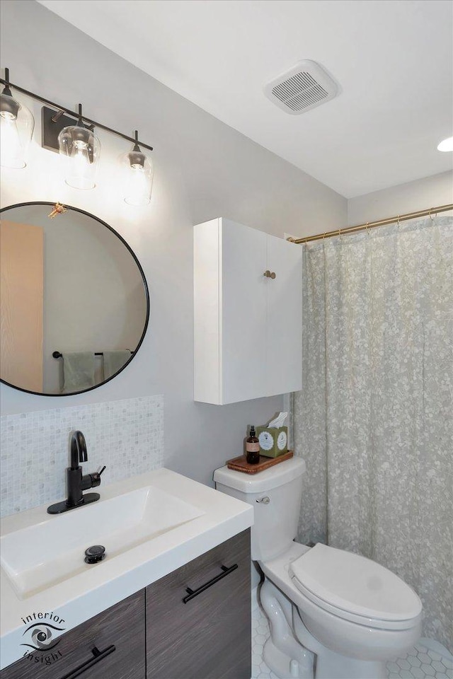 1525 Raymond Dr Unit 103, Naperville, IL 60563 - bathroom with toilet, vanity, tasteful backsplash, and a shower with shower curtain