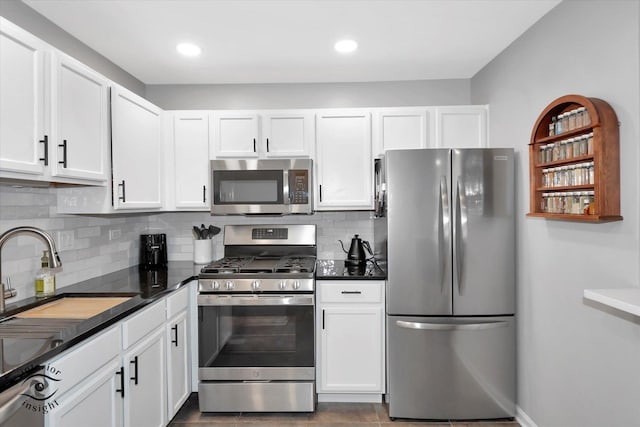 1525 Raymond Dr Unit 103, Naperville, IL 60563 - kitchen with stainless steel appliances, white cabinets, dark countertops, backsplash, and a sink