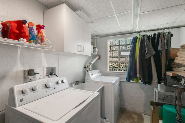 clothes washing area featuring washing machine and dryer, cabinet space, and carpet floors