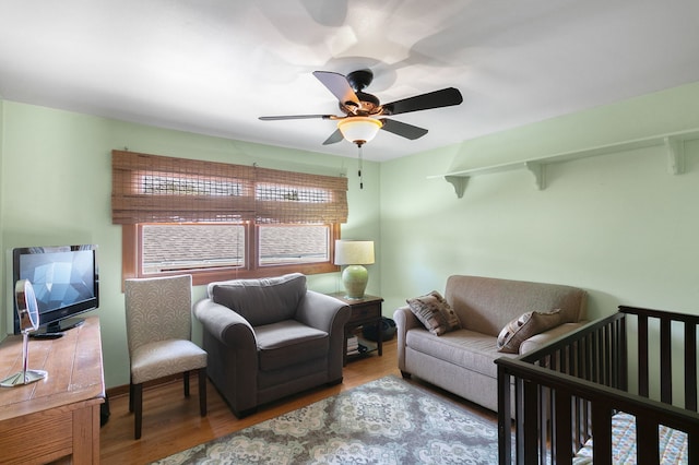 living room with ceiling fan and wood finished floors