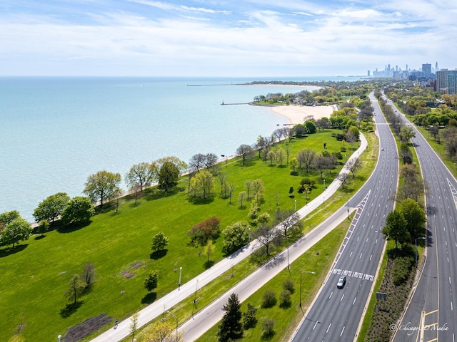 view of urban area featuring a major roadway and a nearby body of water
