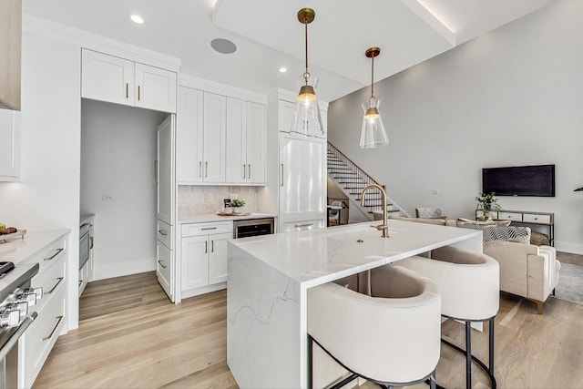 828 E Franklin Ave, Naperville, IL 60540 - kitchen featuring light wood-style floors, open floor plan, white cabinetry, decorative light fixtures, and recessed lighting