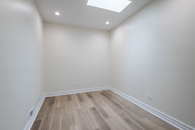 1013 W 18th Pl, Chicago, IL 60608 - spare room featuring a skylight, light wood-style flooring, recessed lighting, and baseboards