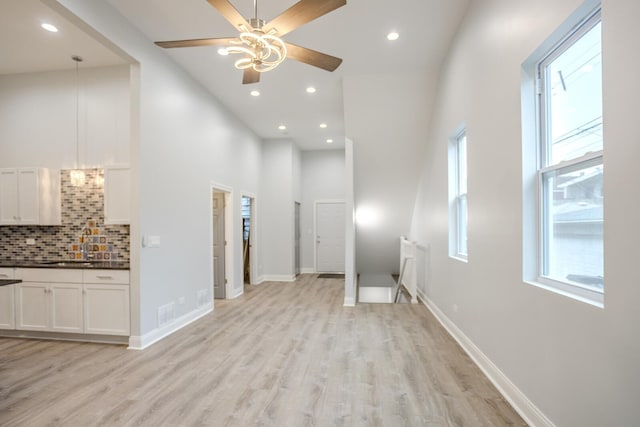 1013 W 18th Pl, Chicago, IL 60608 - corridor featuring an upstairs landing, light wood-style floors, recessed lighting, a towering ceiling, and a sink