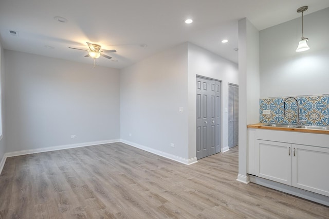1013 W 18th Pl, Chicago, IL 60608 - unfurnished room featuring a ceiling fan, light wood-style floors, recessed lighting, and baseboards