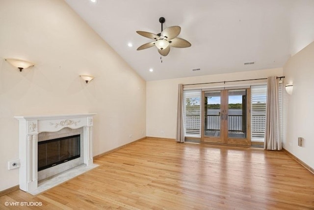 unfurnished living room featuring light wood finished floors, a ceiling fan, a high end fireplace, baseboards, and recessed lighting
