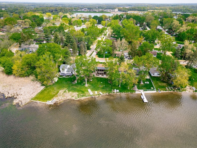 aerial view of property and surrounding area with a large body of water and nearby suburban area