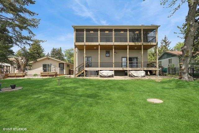 rear view of house with a sunroom and a deck
