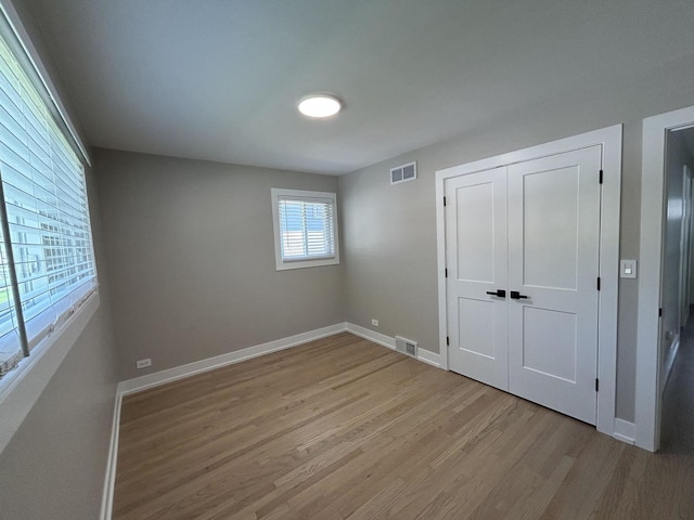 617 S Albert St, Mount Prospect, IL 60056 - unfurnished bedroom with light wood-type flooring, baseboards, and a closet