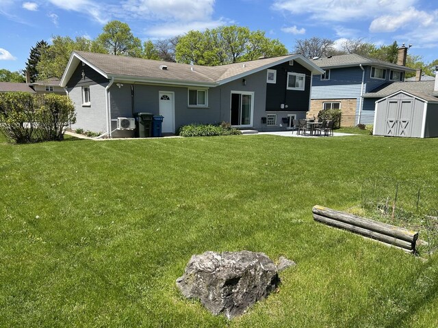 617 S Albert St, Mount Prospect, IL 60056 - back of property with a storage unit, a patio, an outbuilding, and a yard