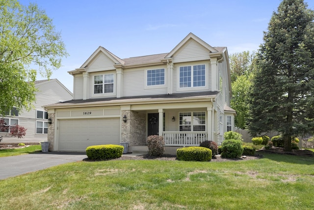 1629 Montclair Dr, Elgin, IL 60123 - view of front of house featuring a porch, asphalt driveway, a front lawn, and an attached garage
