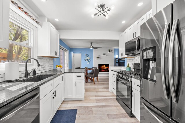 806 71st St, Darien, IL 60561 - kitchen with appliances with stainless steel finishes, a sink, decorative backsplash, dark stone counters, and white cabinets