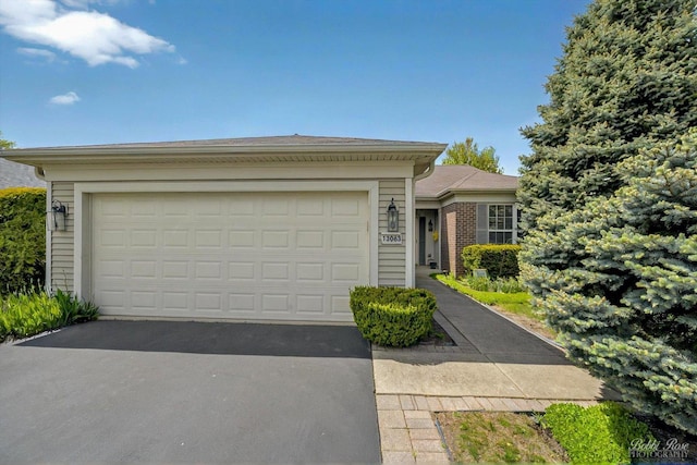 ranch-style home with driveway and an attached garage