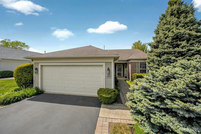 single story home with asphalt driveway and a garage