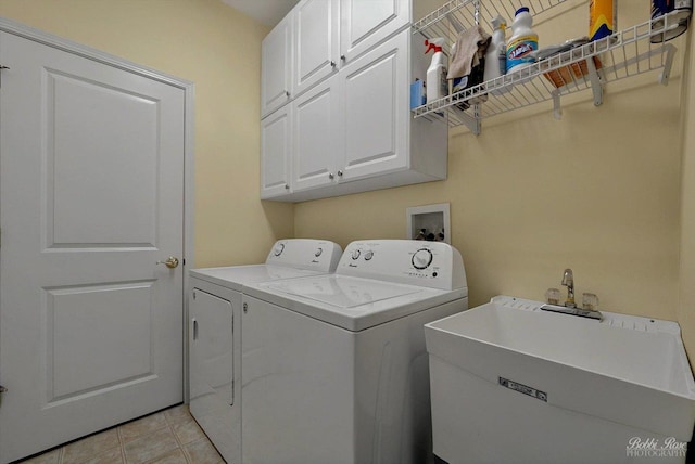 clothes washing area featuring cabinet space and washing machine and dryer