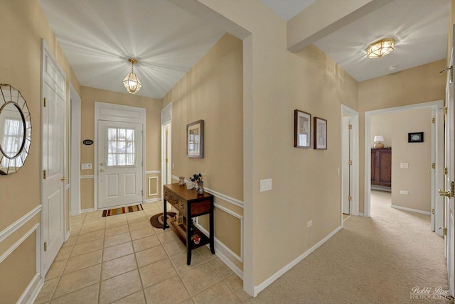 entryway featuring light tile patterned floors and baseboards