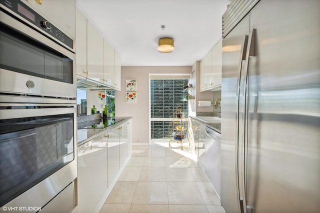100 E Huron St Unit 1806, Chicago, IL 60611 - kitchen with stainless steel appliances, white cabinets, a sink, and healthy amount of natural light