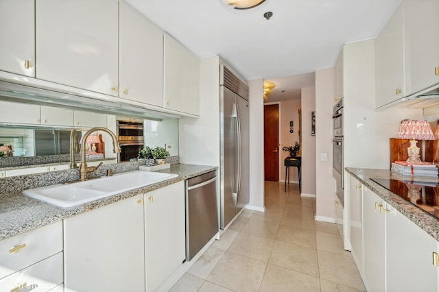100 E Huron St Unit 1806, Chicago, IL 60611 - kitchen featuring stainless steel appliances, a sink, white cabinetry, and light tile patterned floors