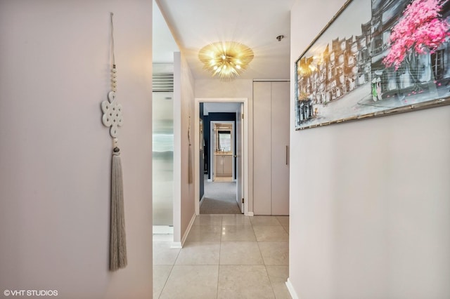 100 E Huron St Unit 1806, Chicago, IL 60611 - corridor featuring baseboards and light tile patterned floors