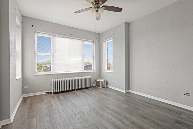 1637 S 48th Ct Unit 9, Cicero, IL 60804 - unfurnished room with radiator, wood finished floors, plenty of natural light, and a ceiling fan
