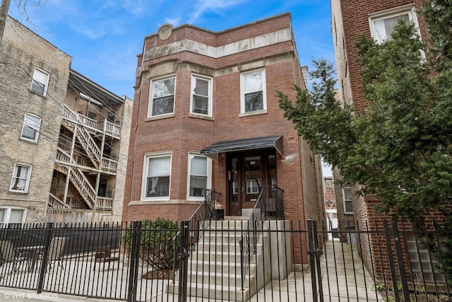 5830 N Glenwood Ave, Chicago, IL 60660 - townhome / multi-family property with brick siding and a fenced front yard