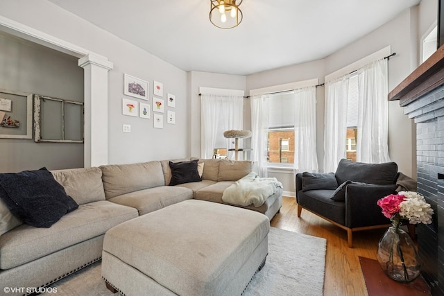 5830 N Glenwood Ave, Chicago, IL 60660 - living room featuring light wood-style flooring and a brick fireplace