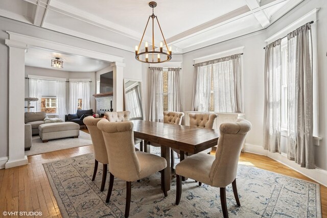 5830 N Glenwood Ave, Chicago, IL 60660 - dining room with light wood-style flooring, a chandelier, coffered ceiling, beam ceiling, and decorative columns