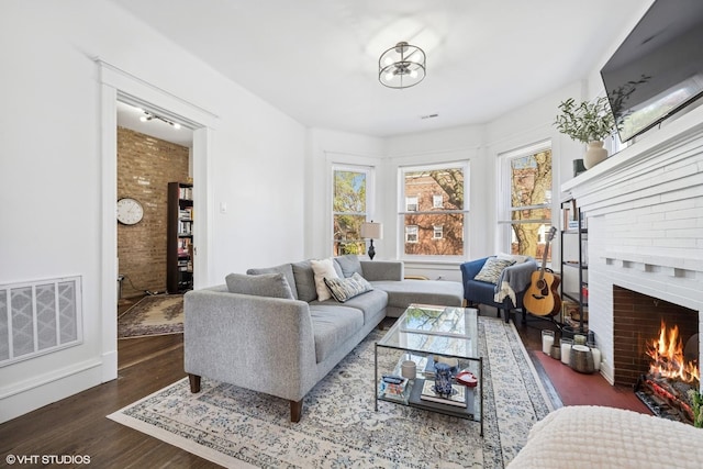 5830 N Glenwood Ave, Chicago, IL 60660 - living room featuring wood finished floors and a brick fireplace