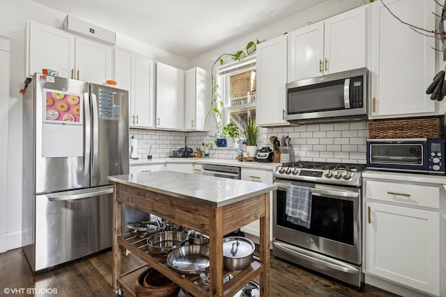 5830 N Glenwood Ave, Chicago, IL 60660 - kitchen featuring appliances with stainless steel finishes, light countertops, white cabinetry, and dark wood finished floors