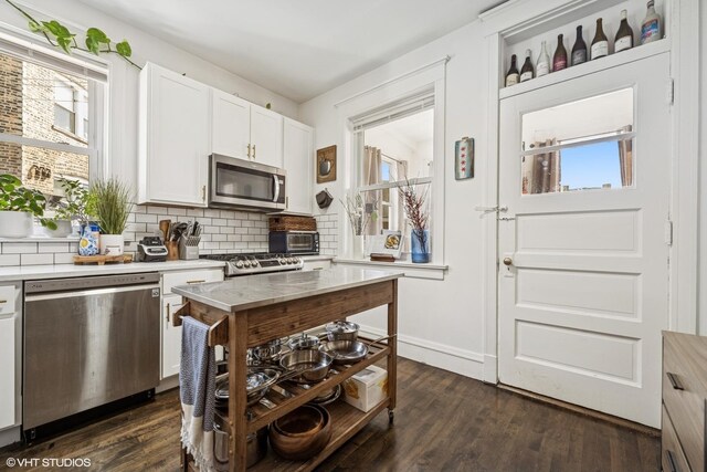 5830 N Glenwood Ave, Chicago, IL 60660 - kitchen with stainless steel appliances, tasteful backsplash, light countertops, white cabinets, and dark wood-type flooring