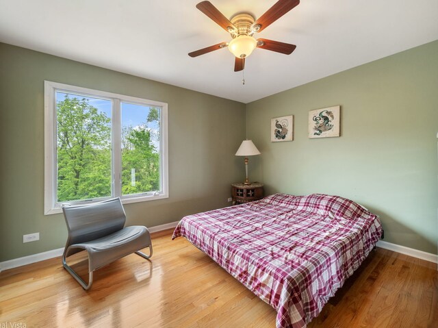 420 Ford Ln, Bartlett, IL 60103 - bedroom with baseboards, light wood-style floors, and a ceiling fan