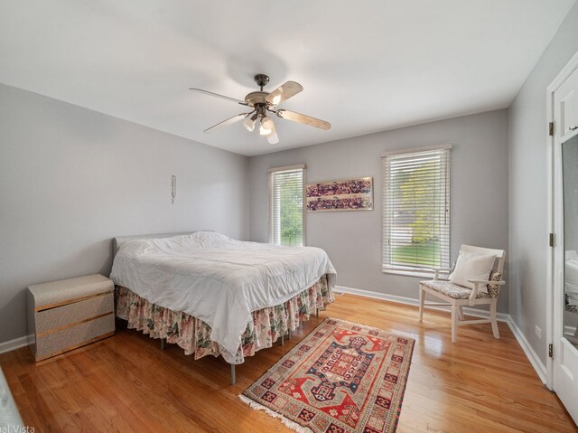 420 Ford Ln, Bartlett, IL 60103 - bedroom with light wood-style floors, baseboards, and ceiling fan